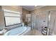 Elegant bathroom with soaking tub, shower and window at 14952 Serene Shores Loop, Lakewood Ranch, FL 34211