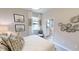 Guest bedroom with ensuite bathroom and decorative wall art at 14952 Serene Shores Loop, Lakewood Ranch, FL 34211