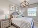 Light and airy bedroom with wood bed frame, patterned bedding, and artwork at 14960 Serene Shores Loop, Bradenton, FL 34211