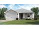 One-story home with gray siding, white garage door, and landscaping at 14960 Serene Shores Loop, Bradenton, FL 34211