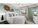 Charming bedroom with light green walls, a comfortable bed, and large window at 15053 Sea Salt Way, Bradenton, FL 34211