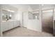 Bathroom with white vanity, frameless shower, and grey tile flooring at 15143 Sea Salt Way, Bradenton, FL 34211