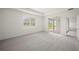 Bedroom with grey carpet, large window and sliding door to patio at 15143 Sea Salt Way, Bradenton, FL 34211