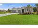 House exterior with gray siding, stone accents, and a three-car garage at 15143 Sea Salt Way, Bradenton, FL 34211