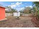 Large backyard with shed, fire pit, and fenced enclosure at 1530 Rollen Rd, Clearwater, FL 33755