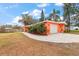 Coral house with a white garage and landscaping at 1530 Rollen Rd, Clearwater, FL 33755