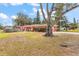 Coral house with a large tree and spacious front yard at 1530 Rollen Rd, Clearwater, FL 33755