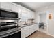 White kitchen with stainless steel appliances and subway tile at 1530 Rollen Rd, Clearwater, FL 33755