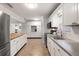 White kitchen with butcher block island and gray counters at 1530 Rollen Rd, Clearwater, FL 33755