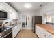 Modern kitchen with white cabinets and butcher block counters at 1530 Rollen Rd, Clearwater, FL 33755