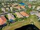 Aerial view of homes and a pond at 15707 Crystal Waters Dr, Wimauma, FL 33598