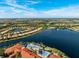 Expansive community view with lakefront clubhouse and tennis courts at 15707 Crystal Waters Dr, Wimauma, FL 33598