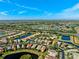 Aerial view of houses and waterways on a sunny day at 15707 Crystal Waters Dr, Wimauma, FL 33598