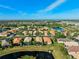 Aerial view of neighborhood with houses and lake at 15707 Crystal Waters Dr, Wimauma, FL 33598