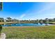 Picturesque backyard view of a lake with lush grass at 15707 Crystal Waters Dr, Wimauma, FL 33598