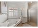 Bathroom with corner bathtub, vanity, and shower at 15707 Crystal Waters Dr, Wimauma, FL 33598