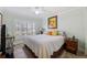 Comfortable bedroom with a king-size bed and window with shutters at 15707 Crystal Waters Dr, Wimauma, FL 33598