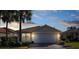 Well-maintained house with a two-car garage and landscaped yard at 15707 Crystal Waters Dr, Wimauma, FL 33598