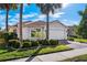 Single-story home with a two-car garage and well-manicured landscaping at 15707 Crystal Waters Dr, Wimauma, FL 33598