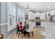 Bright kitchen with white cabinets, breakfast nook and view to living room at 15707 Crystal Waters Dr, Wimauma, FL 33598