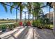 Screened patio with seating and lush tropical landscaping at 15707 Crystal Waters Dr, Wimauma, FL 33598