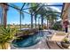 Relaxing screened pool and spa with waterfall feature at 15707 Crystal Waters Dr, Wimauma, FL 33598