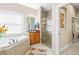 Bathroom with walk-in shower and soaking tub at 15767 Crystal Waters Dr, Wimauma, FL 33598