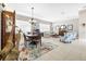 Dining room with wooden table and chairs, and large windows at 15767 Crystal Waters Dr, Wimauma, FL 33598