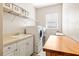 Bright laundry room with washer, dryer, and utility sink at 15767 Crystal Waters Dr, Wimauma, FL 33598