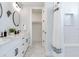 Bathroom with double vanity, marble floors, and shower at 160 174Th Terrace E Dr # B, Redington Shores, FL 33708