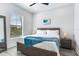 Spacious bedroom with a queen bed, large window and ceiling fan at 160 174Th Terrace E Dr # B, Redington Shores, FL 33708