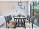 Bright dining area with wood table, black chairs, and window views at 160 174Th Terrace E Dr # B, Redington Shores, FL 33708