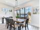 Bright dining room with wood table, black chairs, and large windows at 160 174Th Terrace E Dr # B, Redington Shores, FL 33708