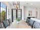 Modern dining room with wood table and black chairs, near patio doors at 160 174Th Terrace E Dr # B, Redington Shores, FL 33708