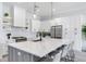 Modern kitchen with white cabinets, stainless steel appliances and a large island at 160 174Th Terrace E Dr # B, Redington Shores, FL 33708