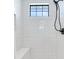 Walk-in shower with white subway tile and built-in seat at 160 174Th Terrace E Dr # B, Redington Shores, FL 33708