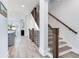 Elegant staircase with dark wood railings and light gray flooring at 160 174Th Terrace E Dr # B, Redington Shores, FL 33708