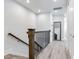 Modern staircase with dark wood railings and light gray walls at 160 174Th Terrace E Dr # B, Redington Shores, FL 33708