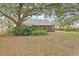 Serene backyard with screened porch, and large oak trees at 16104 Stowe Ct, Tampa, FL 33647