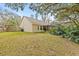 Expansive backyard with screened enclosure and green grass at 16104 Stowe Ct, Tampa, FL 33647