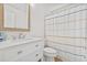 Clean bathroom with white vanity, shower, and striped curtain at 16104 Stowe Ct, Tampa, FL 33647