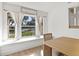 Window seat with sheer curtains and a wooden dining table at 16104 Stowe Ct, Tampa, FL 33647