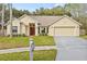 Updated single-story home with a two-car garage and landscaped lawn at 16104 Stowe Ct, Tampa, FL 33647