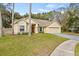 Landscaped yard and driveway leading to a charming house at 16104 Stowe Ct, Tampa, FL 33647