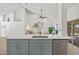 Modern kitchen island with white quartz countertop and light blue cabinets at 16104 Stowe Ct, Tampa, FL 33647