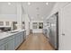 Modern kitchen with light blue cabinets and hardwood floors at 16104 Stowe Ct, Tampa, FL 33647