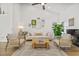 Living room with light walls, hardwood floors, and a cozy seating arrangement at 16104 Stowe Ct, Tampa, FL 33647