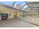 Extended screened porch with deck and backyard view at 16104 Stowe Ct, Tampa, FL 33647