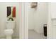 Clean bathroom includes a toilet, linen closet, and shelving at 17638 Happytrails St, Land O Lakes, FL 34638