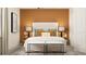 Bedroom with full bed, orange accent wall, and neutral bedding at 17638 Happytrails St, Land O Lakes, FL 34638